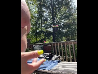 Letting my neighbor watch me sunbathe topless on the deck