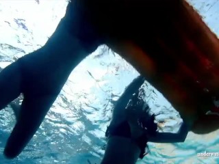 Mia and Petra undress eachother in the swimmingpool