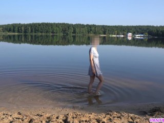 Sexy girl undresses and swims naked in public beach
